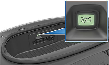 A button inside the front trunk with an image of a car with its trunk open