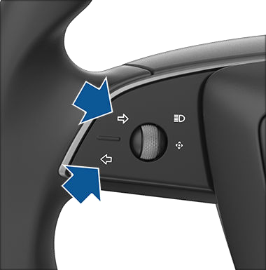 Closeup of left and right turn signals on steering yoke.