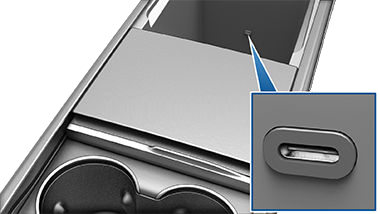 Front console with front compartment open, revealing two USB ports on rear wall of compartment