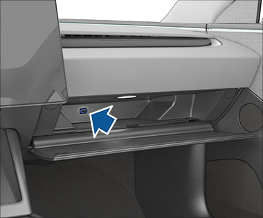 Glovebox open, revealing a USB drive in the USB port