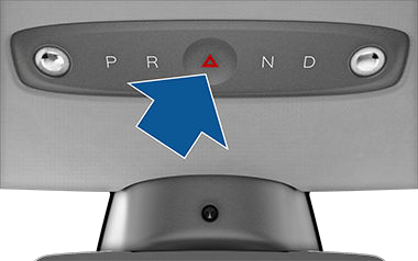 Overhead console drive mode selector with arrow pointing to hazard warning light button in the middle.